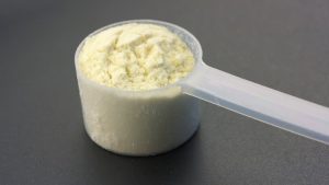 scoop of white protein powder